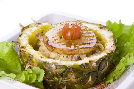 Exotic salad in pineapple on white groundの写真素材