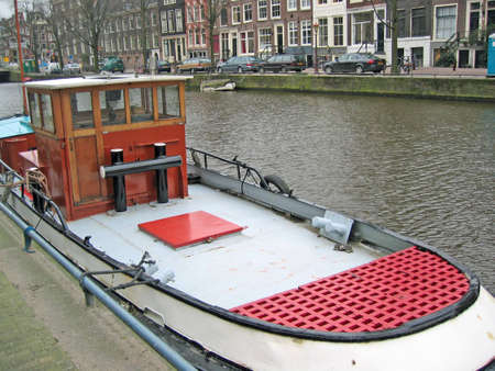 Typical Amsterdam boat on a canal, dockedの写真素材