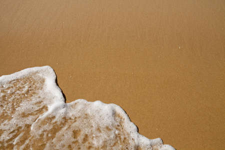 Wave over sand - with upper copy space