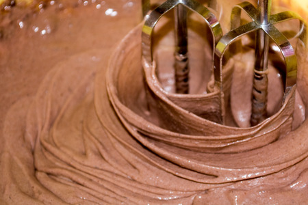 Mixing chocolite for cake with electric mixerの写真素材
