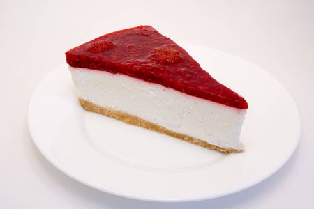 Cheesecake slice on a white plate isolated on a white backgroundの写真素材