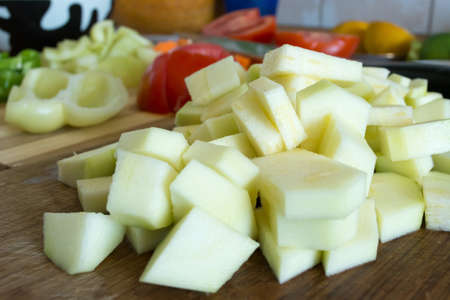Kitchen full of various vegetables. Pepper, tomatoes sliced and ready to be boiledの写真素材