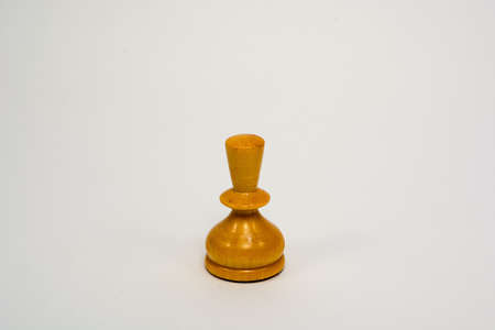 Old wooden chess piece white pawn isolated on white backgroundの写真素材