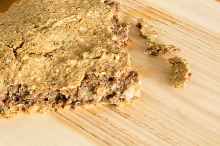 Part of just baked, fresh, domestic unleavened barley bread on the wooden plateの写真素材