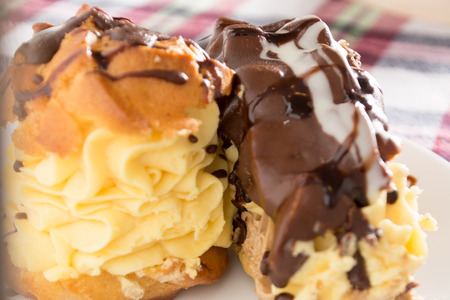 Cream Pie. Two layers of puff pastry filled with whipped cream decorated with melted chocolate on a white plateの写真素材
