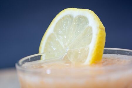 Fresh lemonade with ginger decorated with  lemon on the dark backgroundの写真素材