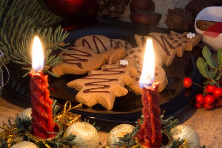 Atmospheric shoot of christmas eve with cookies and candlesの写真素材