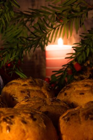 Muffins on Christmas Eve lit by candlesの写真素材