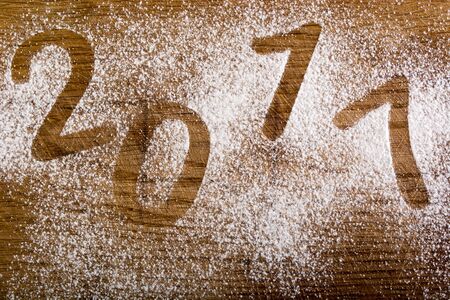 Wooden plate covered with sugar with sign 2017の写真素材