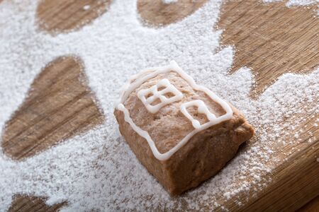 Small lonely gingerbread cookie covered with sugar on plate