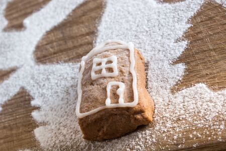 Small lonely gingerbread cookie covered with sugar on plateの写真素材