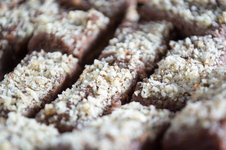 Close up of chocolate cake with walnut cut into squaresの写真素材