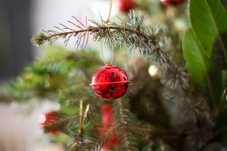 Girl decorating Christmass bouqet  with red ornaments, pines and tree branches
