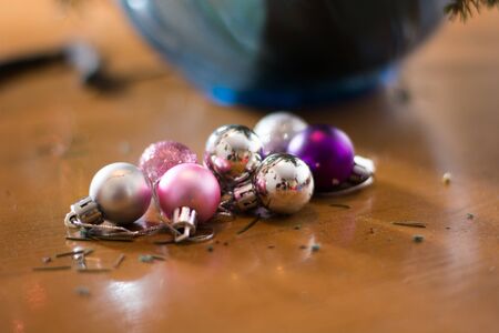 Girl decorating Christmass bouqet  with red ornaments, pines and tree branchesの写真素材