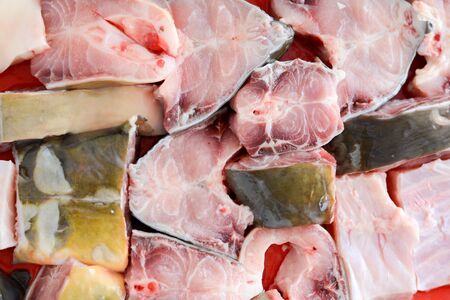 Fish stakes on plate ready to be covered in bread crumbs and baked shot from upper angleの写真素材