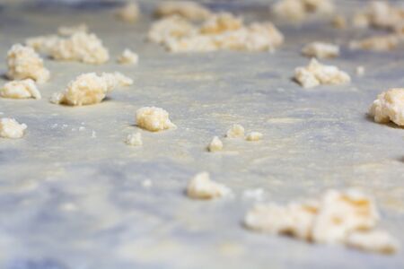 Homemade Phyllo or strudel dough with cheese on a home table cloth ready for cheese burek pie or other kind of traditional pastry.の写真素材