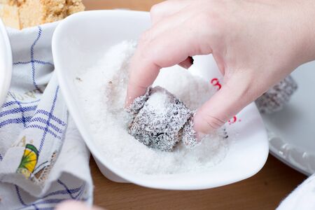 Female hands making brownies with coconut flour and chocolate