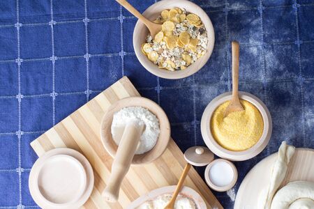 Various ingredients in woodwork dishes. Cereals, wheat, salt, and other ingredients visibleの写真素材