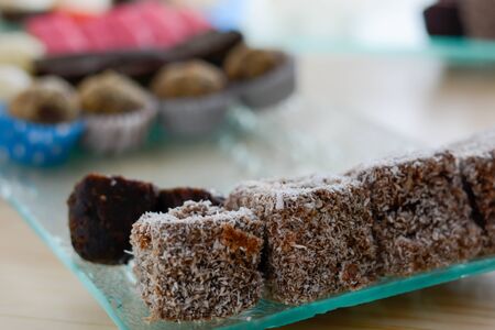 Colorful and delicious brownies with coconut flour cakes arranged on glass plate for celebration of...