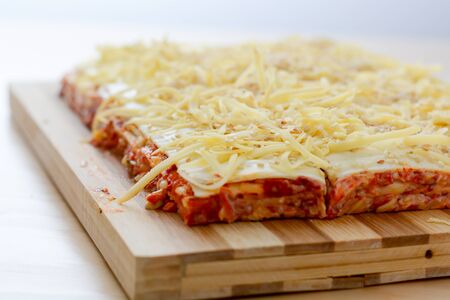 Salt cake with cheese and red paprika on wooden tableの写真素材