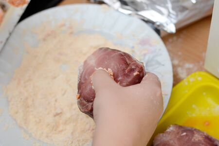 Preparing fish steaks with wheat flour and bread crumbs, preparing it for bakingの写真素材