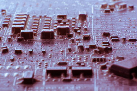 Surface-mount dusty smd components on used electronic circuit board close-up.の写真素材