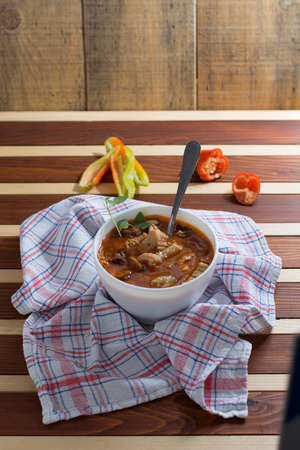 Traditional and very popular serbian dish from beef tripe served on wooden table