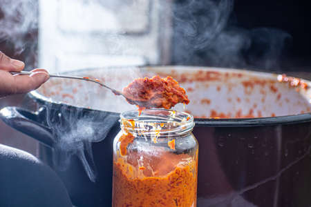 Freshly cooked ajvar in the glass jar. Shot from above