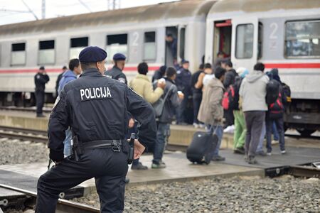 October 5, 2015; Tovarnik in Croatia. Croatian police assist refugees get into train which will go to Hungary.のeditorial素材