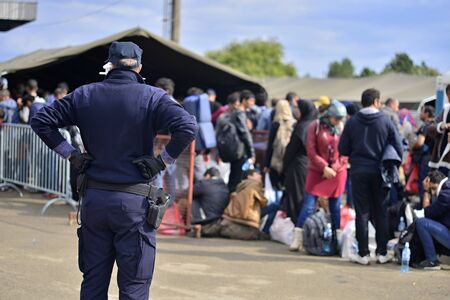 October 5, 2015; Tovarnik in Croatia. Croatian police assist refugees get into train which will go...