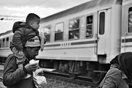 October 5, 2015; Tovarnik in Croatia. Croatian police assist refugees get into train which will go to Hungary.のeditorial素材