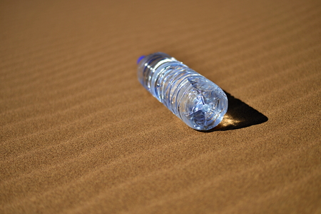 Bottle of water in Saharaの写真素材