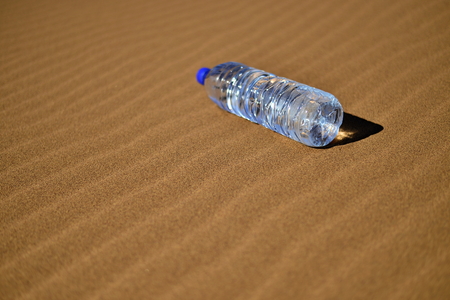 Bottle of water in Saharaの写真素材
