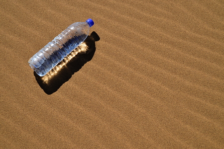 Bottle of water in Saharaの写真素材