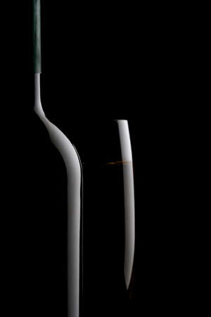 Wine bottle and wine glass on black backgroundの写真素材