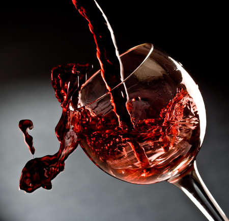 Red wine pouring into a wine glassの写真素材