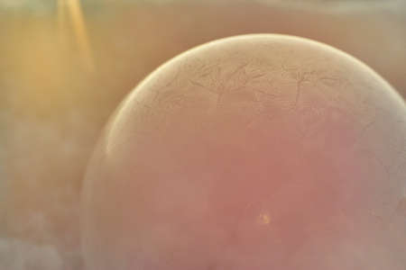 Subtle winter ornaments on a frozen bubbleの写真素材