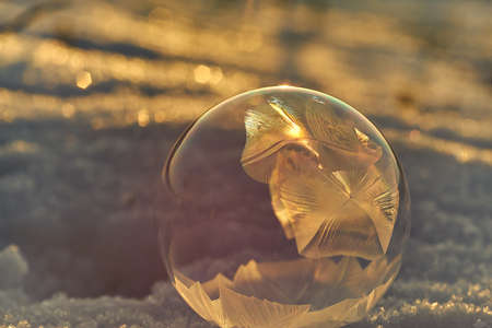 Bubble freezing on a cold winter day shot against the sun
