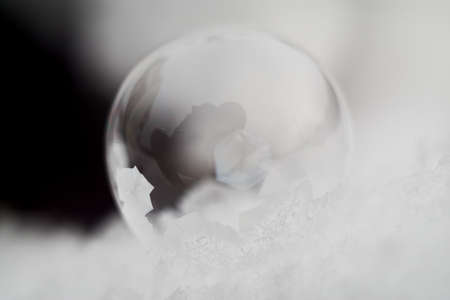 Frozen Soap Bubble on a Snowy Ground against the Blackの写真素材