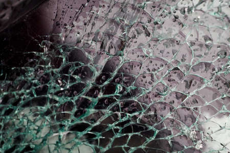 A broken windshield of a car crashed in a car accident