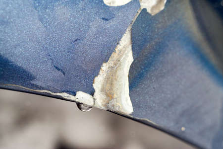 Damaged car bumper with a drop of water on itの写真素材
