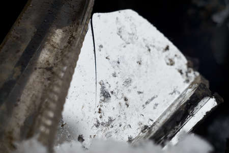 Inside a broken headlight of a damaged carの写真素材