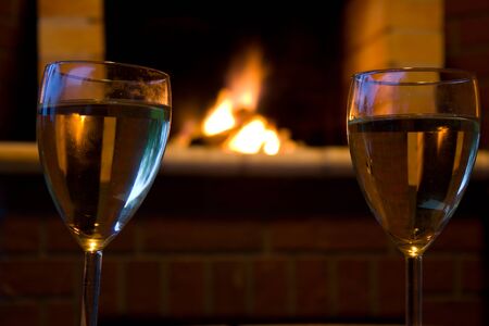 A relaxing evening - glass of wine firesideの写真素材
