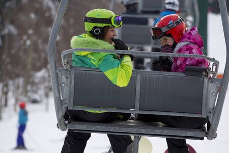 Girls resting while riding a chairlift.Photo taken on: 05/02/2015のeditorial素材