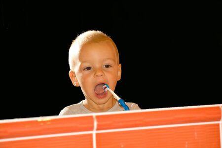 little boy cleans his first milk teeth