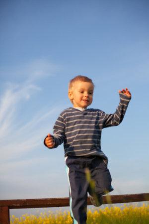 Little boy jumps down from the bench.の写真素材