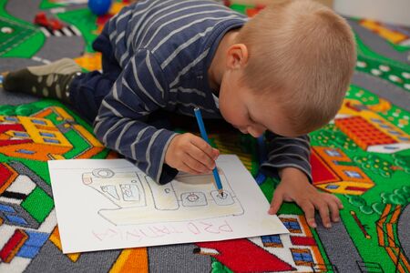 Cute little boy paints a colorful picture Shallow DOF.の写真素材