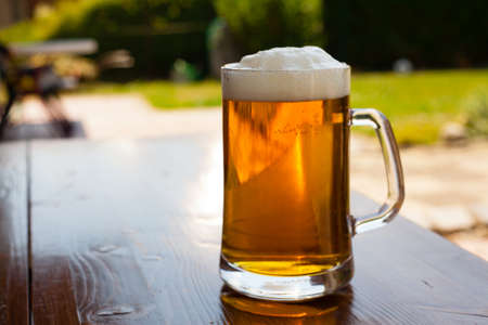 Closeup of a glass of beer in the daylight (shallow DOF).の写真素材