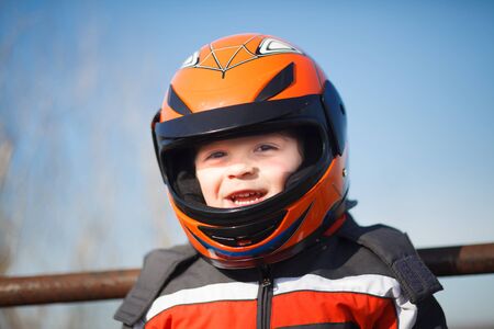 A little boy in a motorcycle helmet prepares to ride.の写真素材