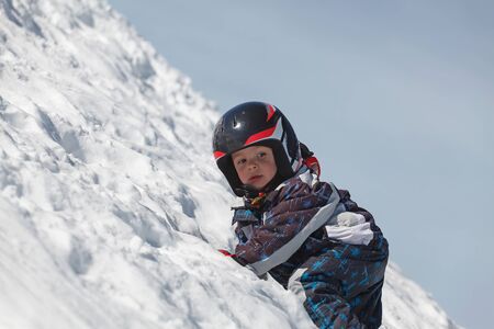 Portrait of a young boy in the snow (shallow DOF)の写真素材